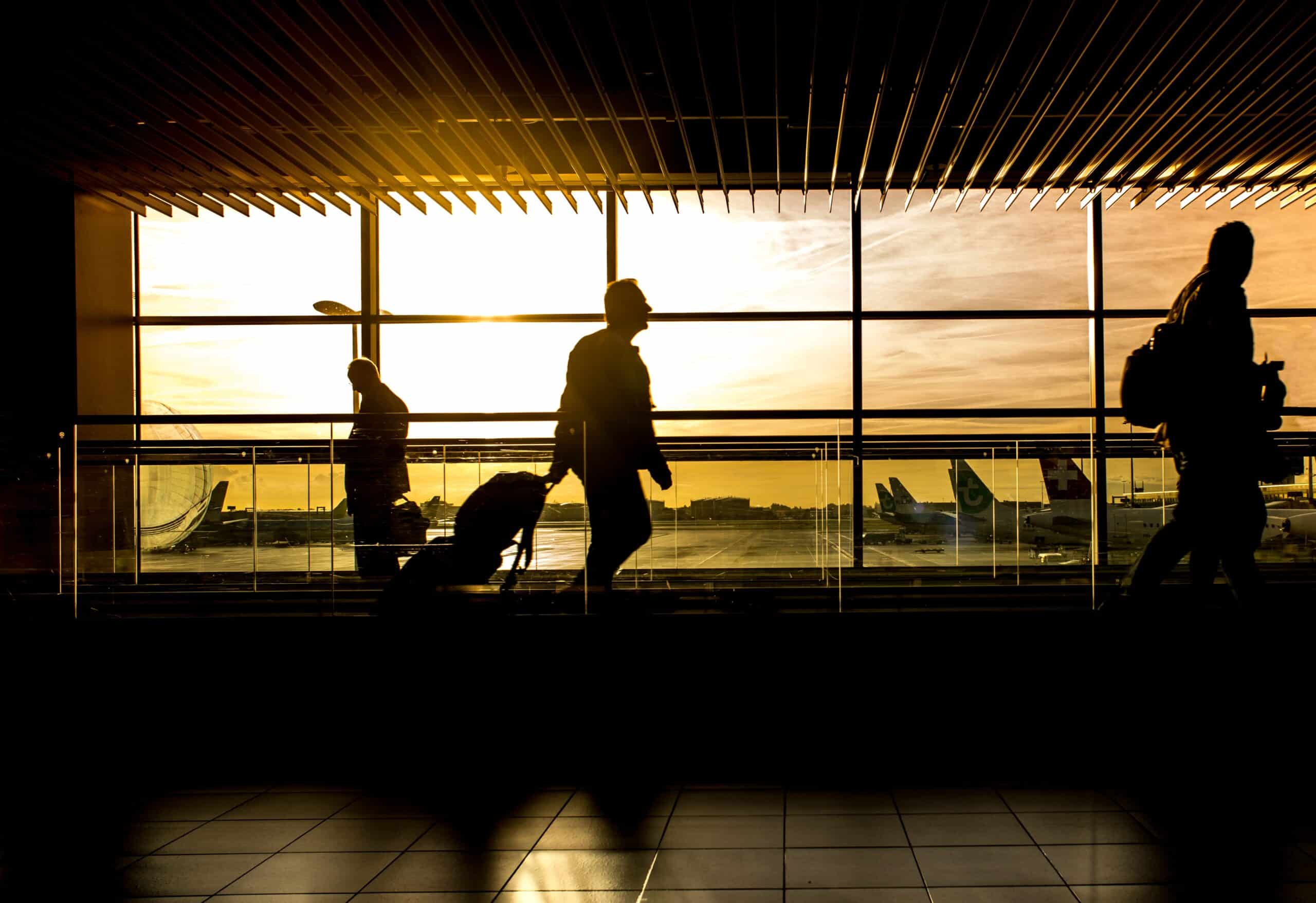People walking at Airport in front of window - Sydney Criminal Lawyers - criminal defence lawyers