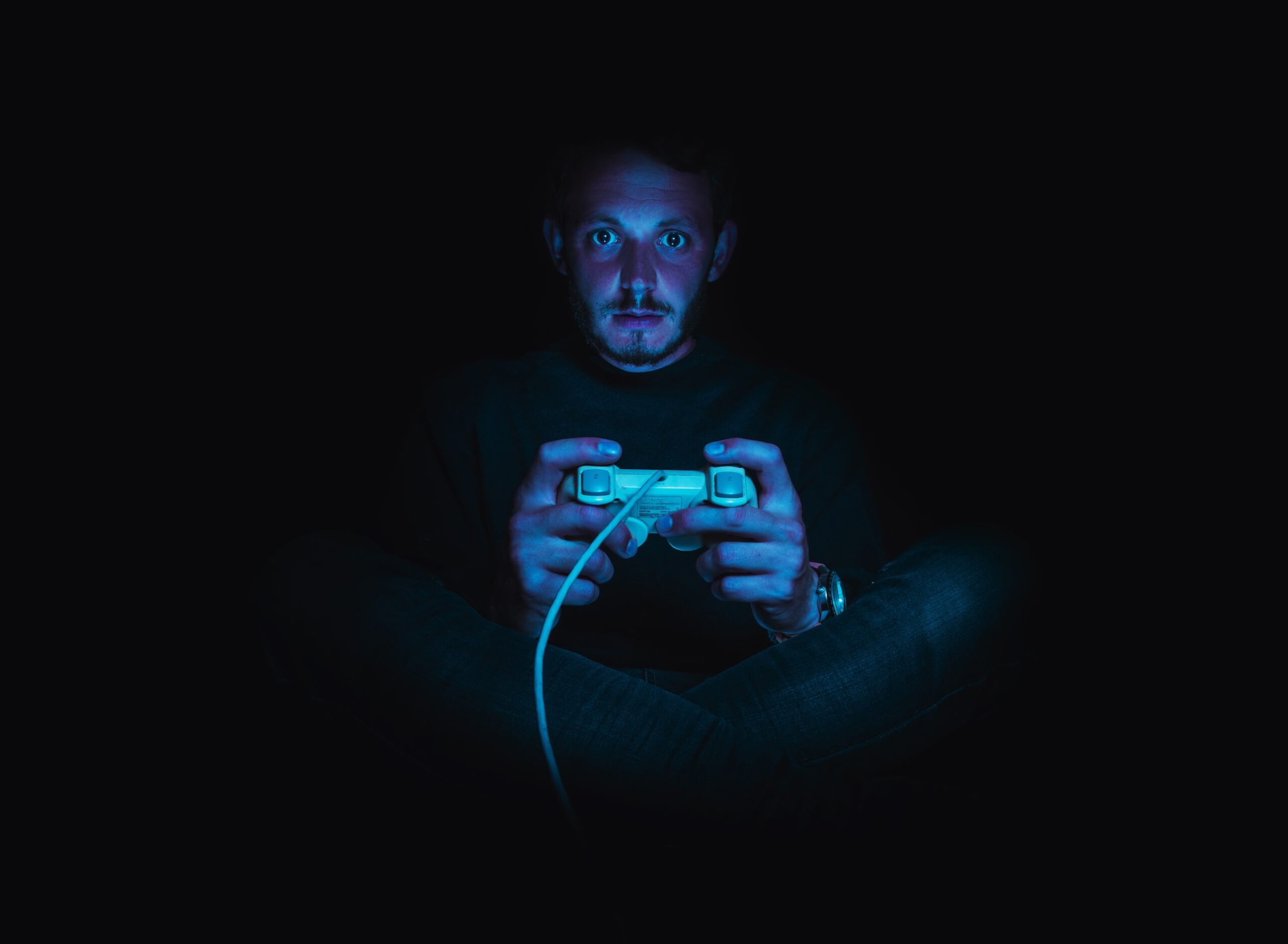 Man playing a game in the dark